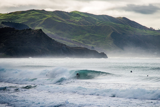 Photo of a surfer in a barrel at Wainui Beach in Gisborne