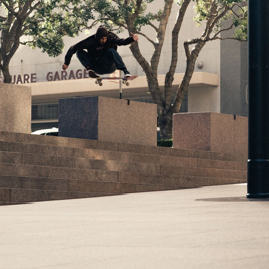 Globe sponsored sakateboarder doing a massive ollie down some steps