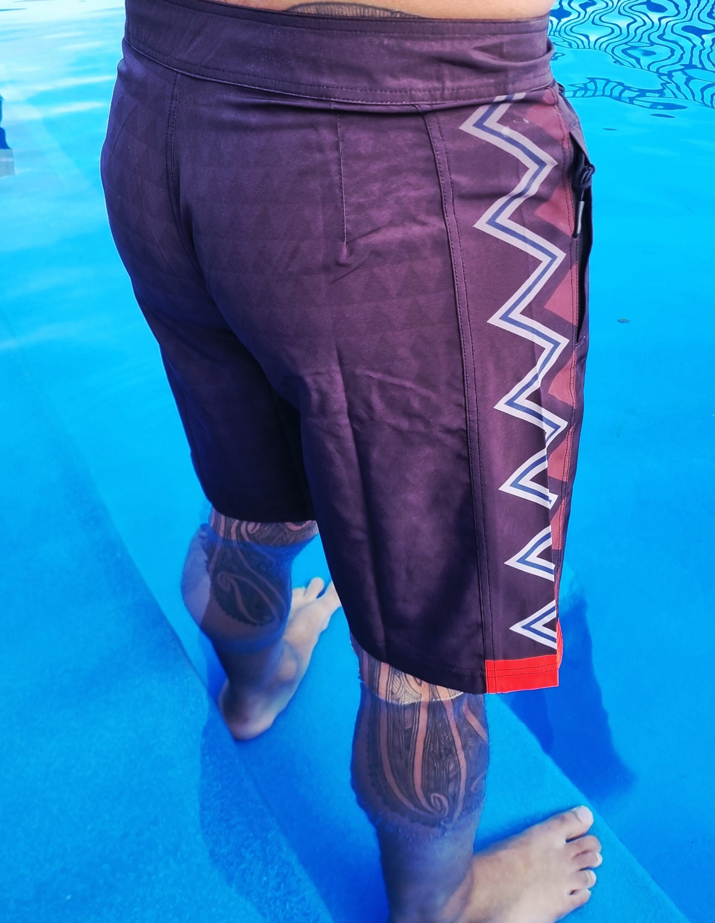 Wai-Tai Aotearoa Taniwha 4 Way Stretch Maori Boardshorts in pool form rear and right side