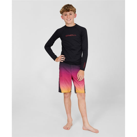 O'Neill Thermo X Long Sleeve Youth Rash Top in black on youth model in multi coloured boardshorts