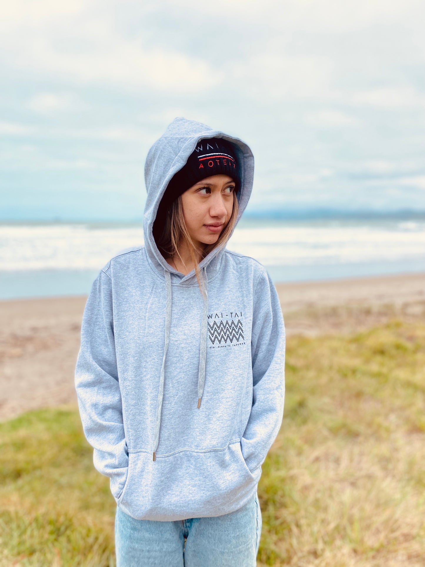 Wai-Tai Kaitiaki Maori Shark Hoodie in grey marle from front at Midway Beach Gisborne