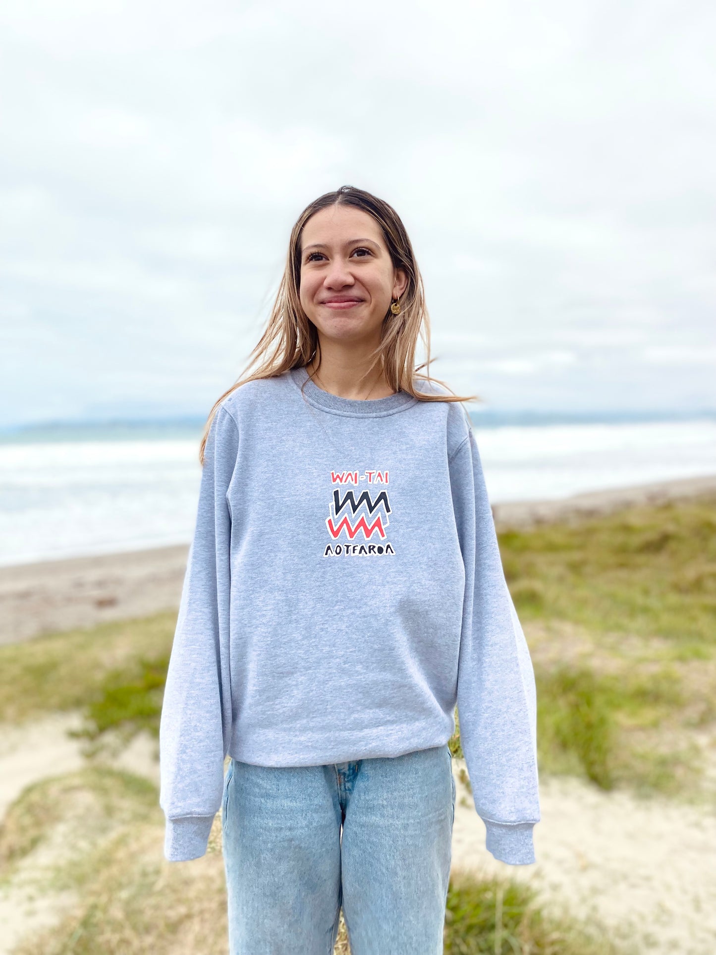Wai-Tai Aotearoa Mura Crew in grey marle from front on model at Midway Beach in Gisborne