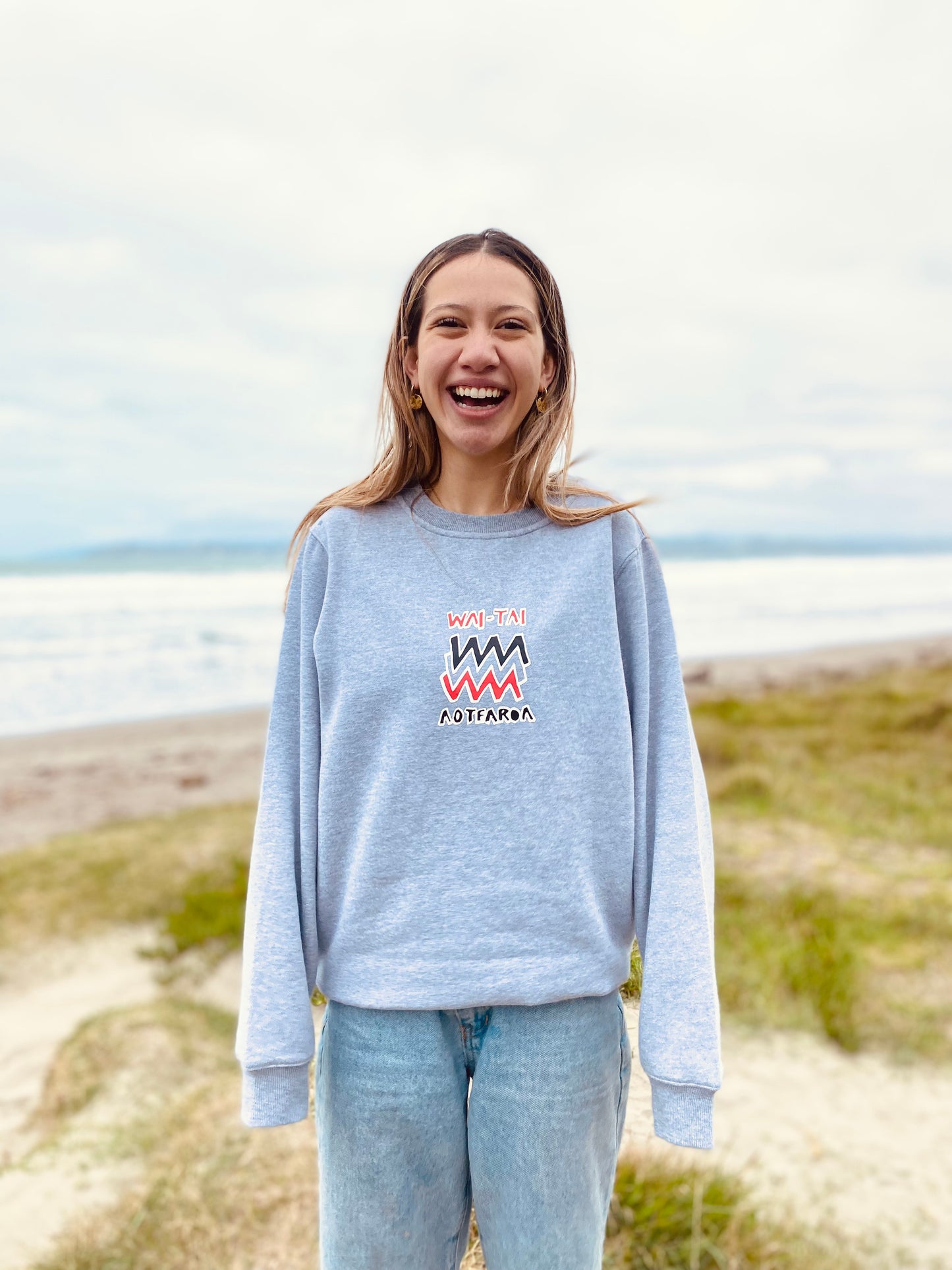 Wai-Tai Aotearoa Mura Crew in grey marle from front on model at Midway Beach in Gisborne