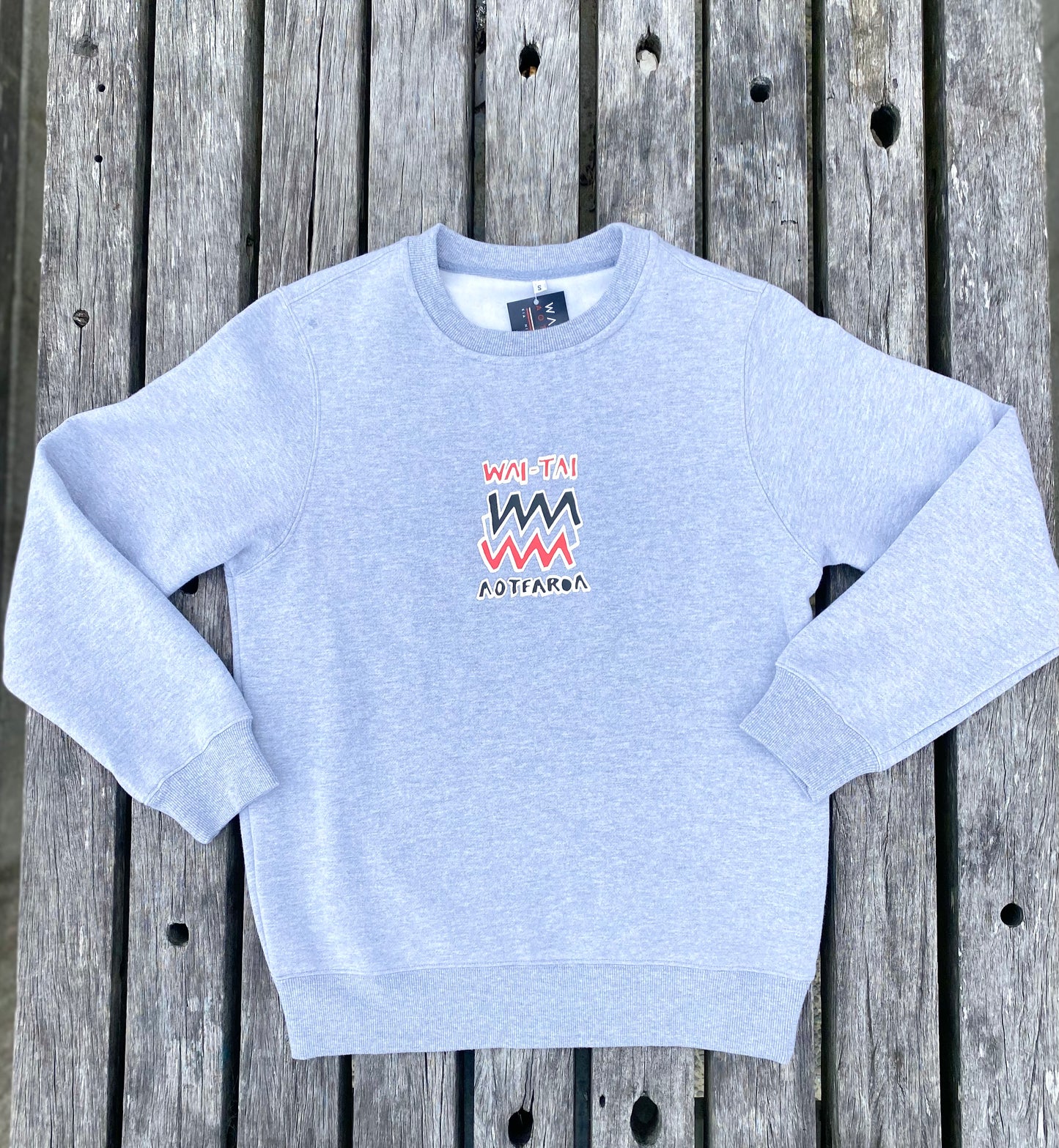 Wai-Tai Aotearoa Mura Crew in grey marle flat lay from front at Midway Beach in Gisborne