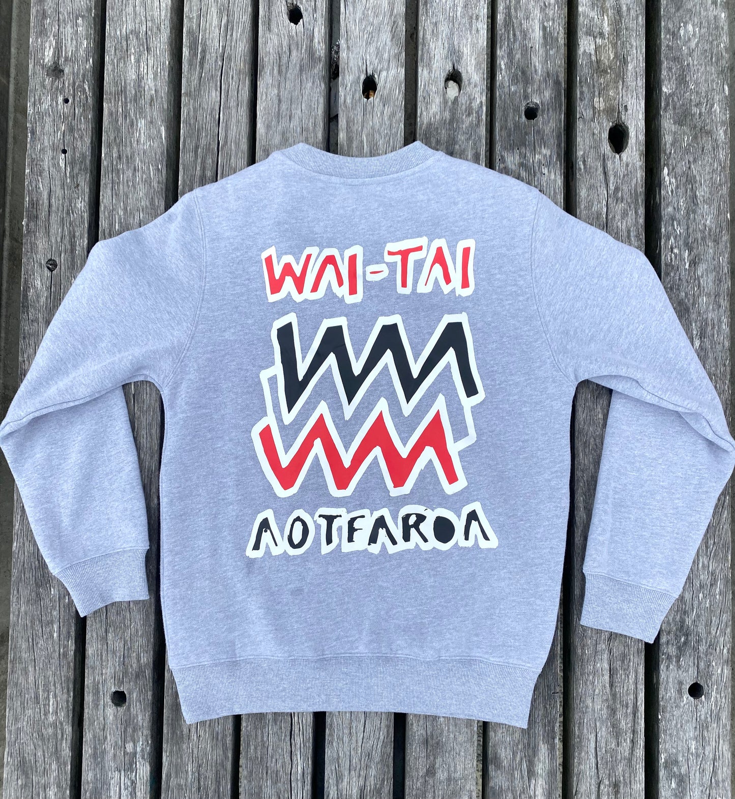 Wai-Tai Aotearoa Mura Crew in grey marle flat lay from rear at Midway Beach in Gisborne