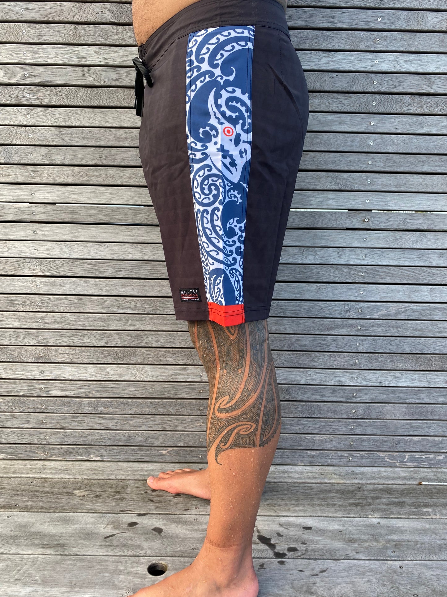 Wai-Tai Aotearoa Taniwha 4 Way Stretch Maori Boardshorts from side showing Taniwha panel