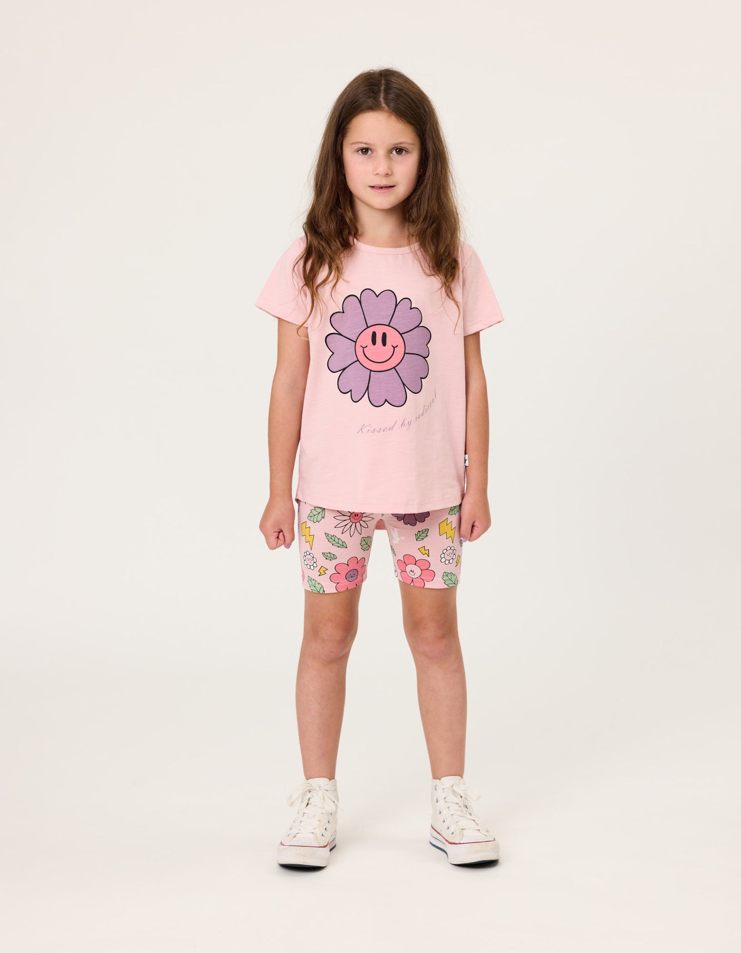 Kissed By Radicool Smiley Flowers Bike Shorts on dark-haired model wearing pink tee from front