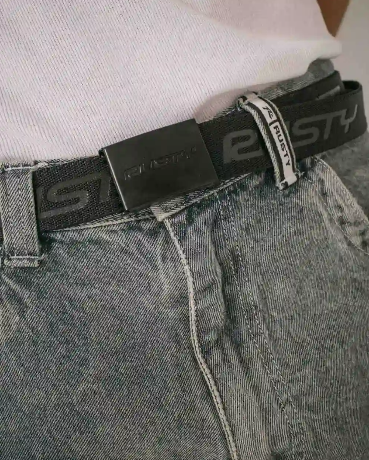 Rusty Flip Daddy Reversible Elastic Webbing Belt in black in model's jeans close up of front