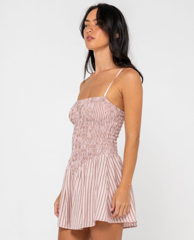 Rusty Mimi Smocked Stripe Mini Dress in pink stripe on model from side