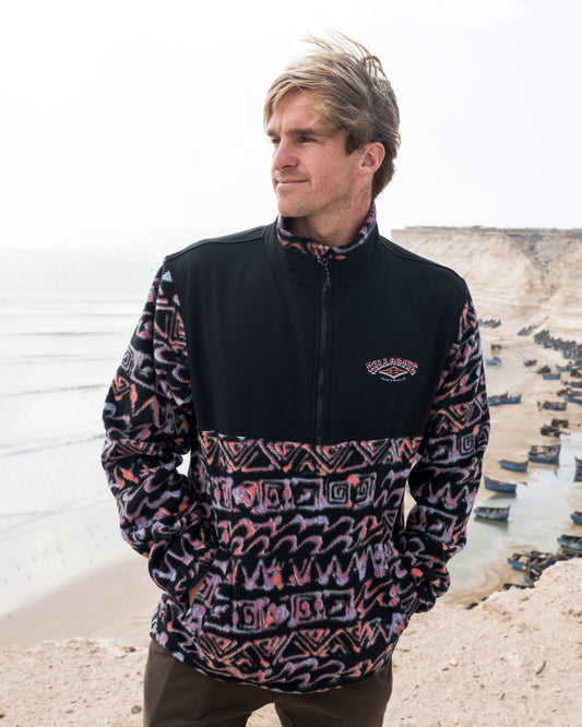 Billabong Boundary Re-Issue Crew Fleece in black and multi coloured on model at beach