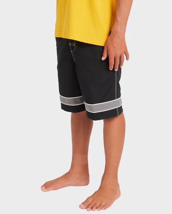 Billabong Boys Throw On 18" Boardshorts 2.0 in black on youth model in yellow t-shirt from side