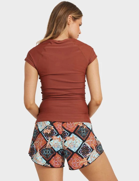 Billabong Forever Folk Swim Womens 3" Volley Shorts in black pebble with multi coloured detail on model in brown rash top from rear