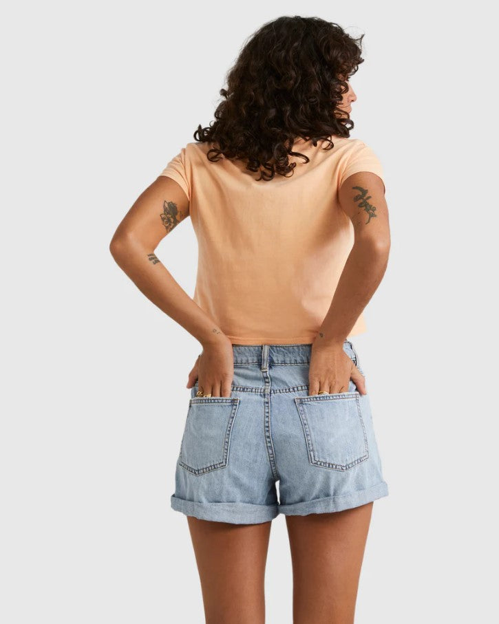 Billabong Frankie 2" Women's Denim Shorts in water blue colourway on model wearing aprict colour tee from rear
