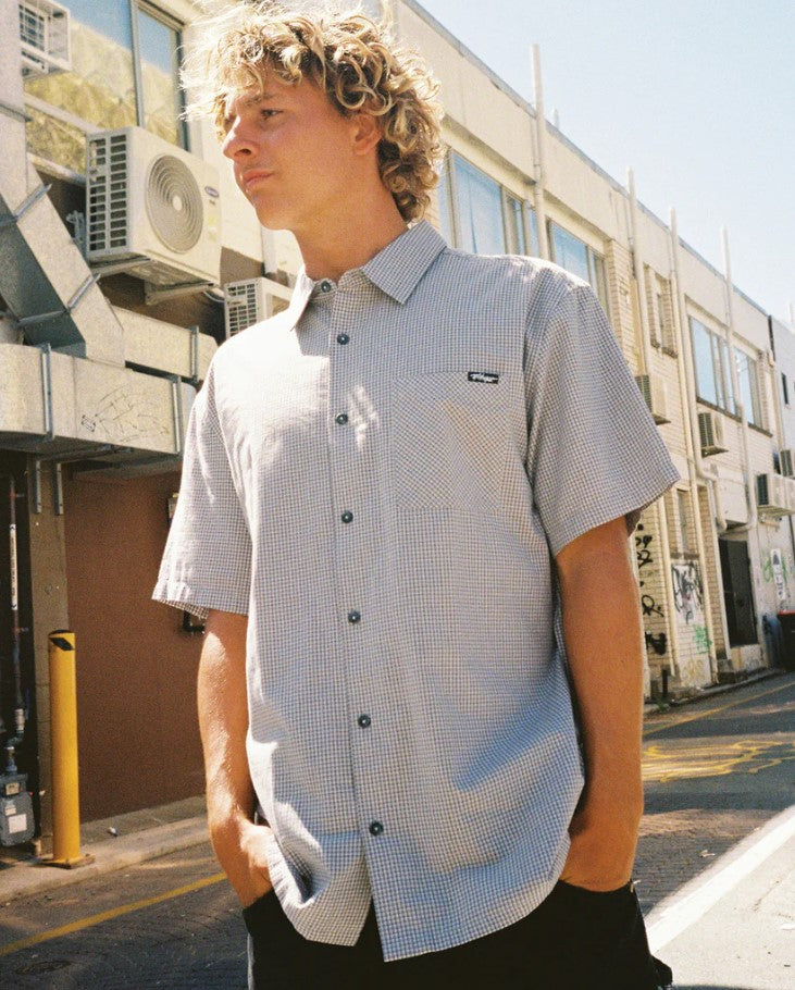Billabong Mens Mogul Short Sleeve Shirt in pewter colourway on model standing in a street in front of buildings