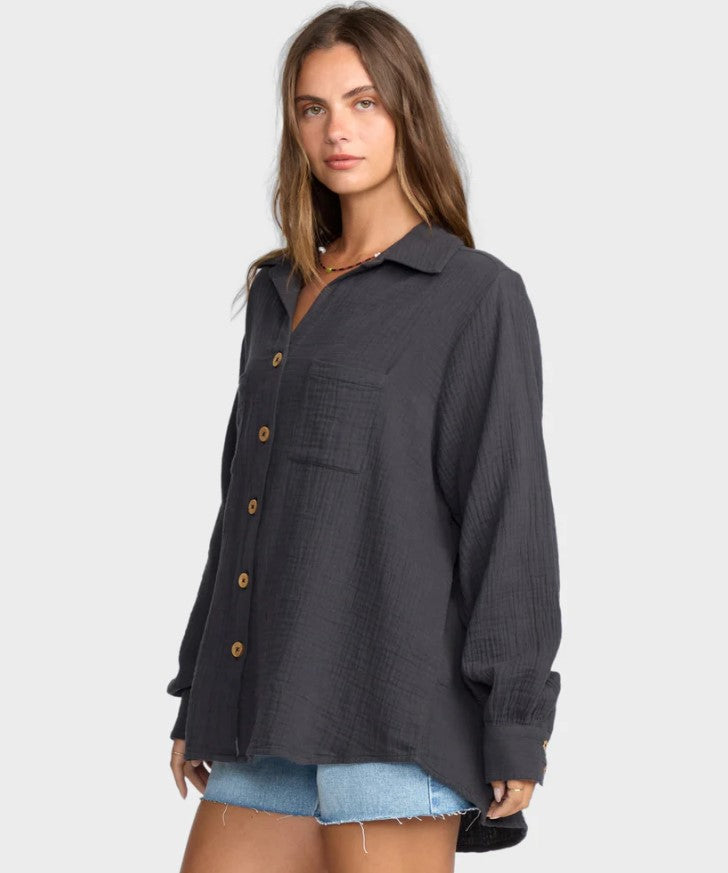 Billabong Swell Blouse in black sands colourway from side/front on model