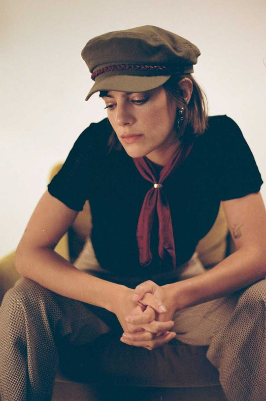 Brixton 20th Anniversary Fiddler Cap in olive on female model