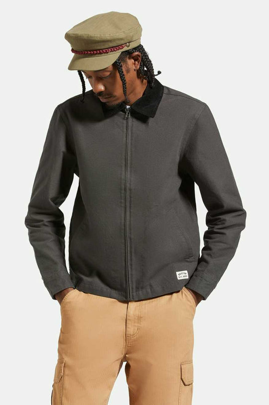 Brixton 20th Anniversary Fiddler Cap in olive on male model