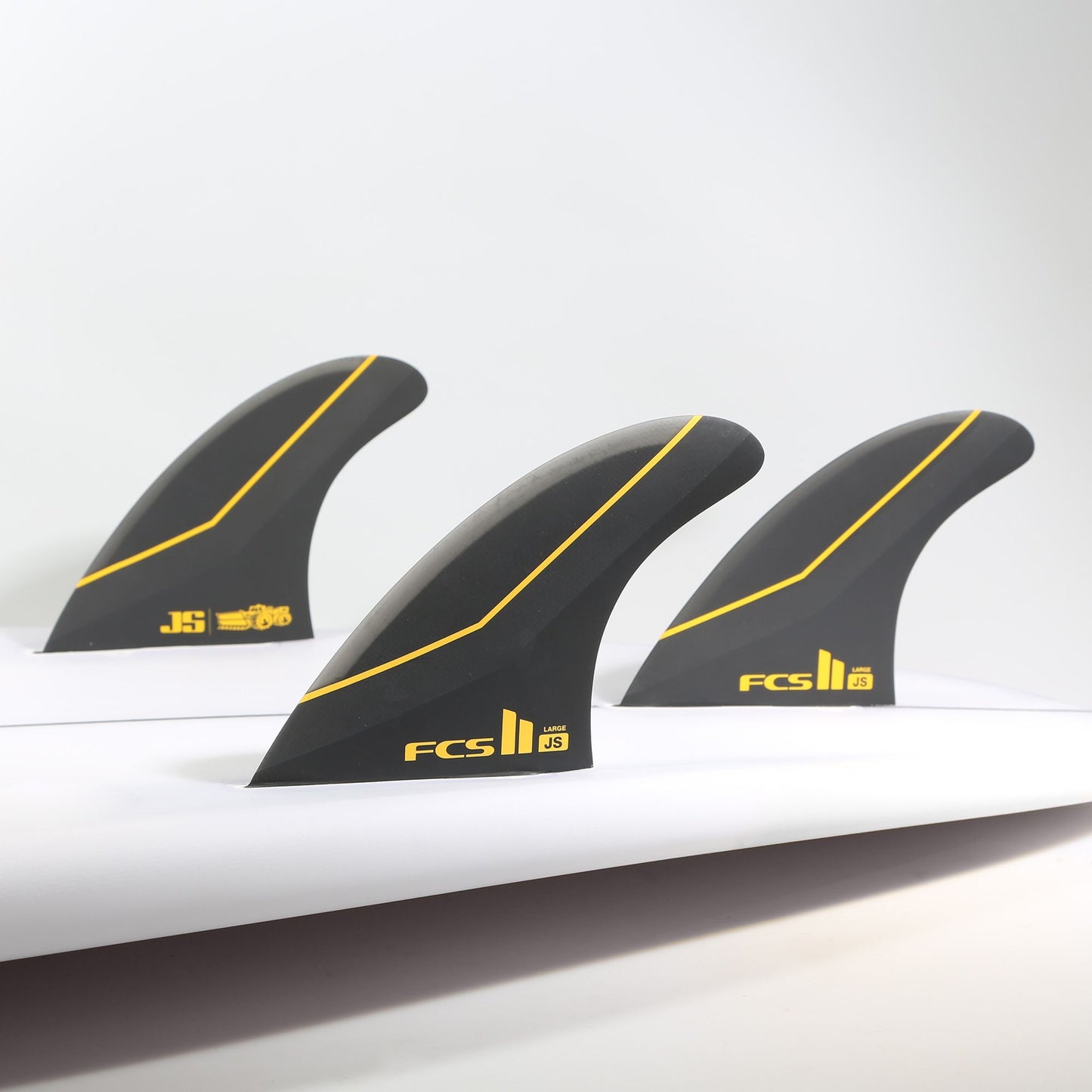 FCS II JS PC Carbon Tri Fin Set in surfboard in black colour