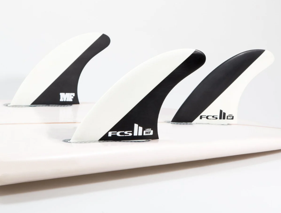 FCS II MF Mick Fanning Grom Tri Surfboard Fins in black in white shown in tail of surfboard