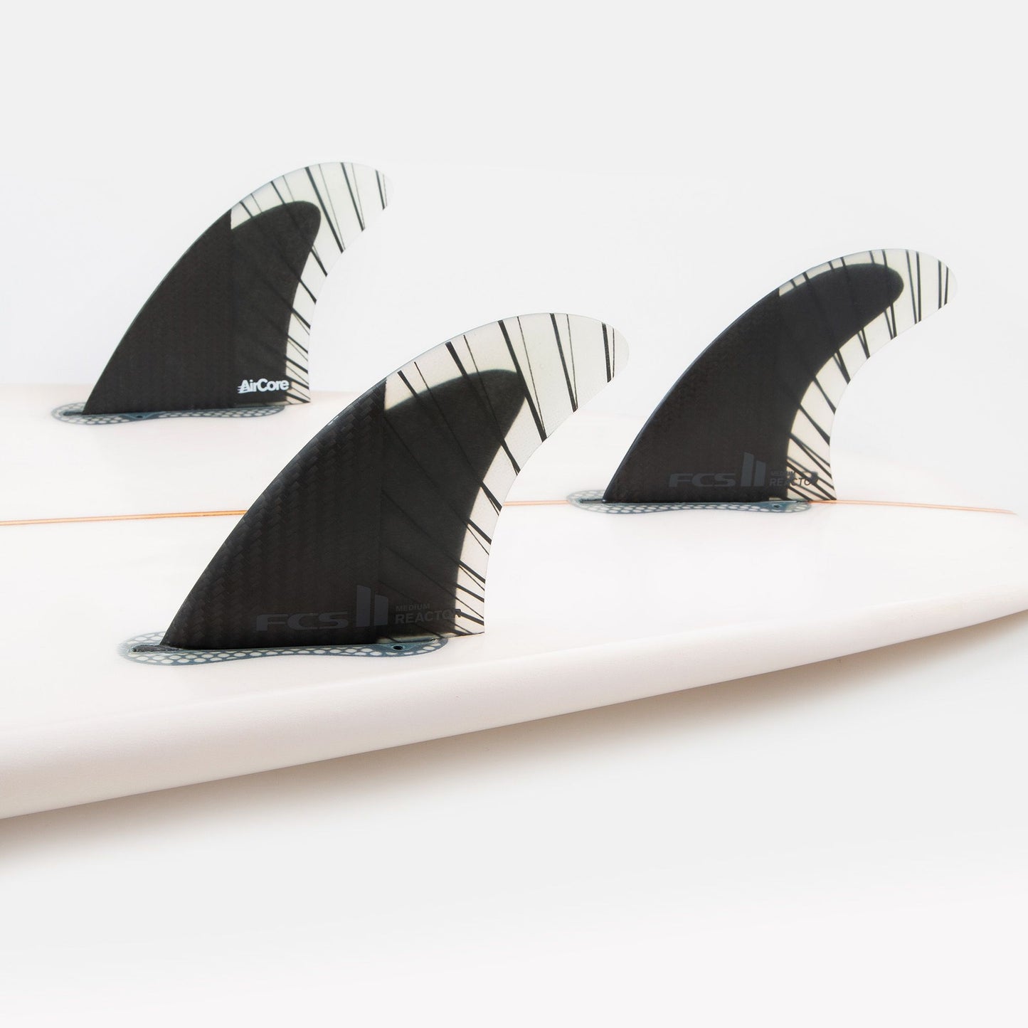 FCS II REACTOR PC CARBON TRI FIN SET LARGE showing all three fins in board