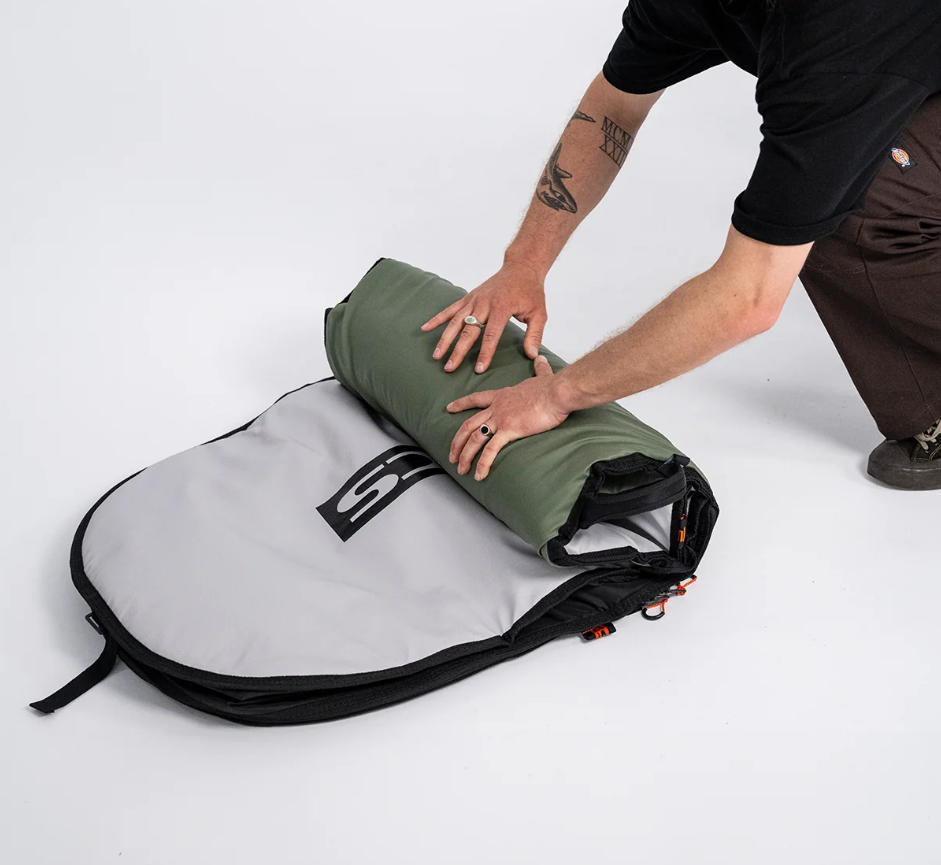 FCS 9'2 Day Runner Longboard Bag in alpine colourway being rolled up