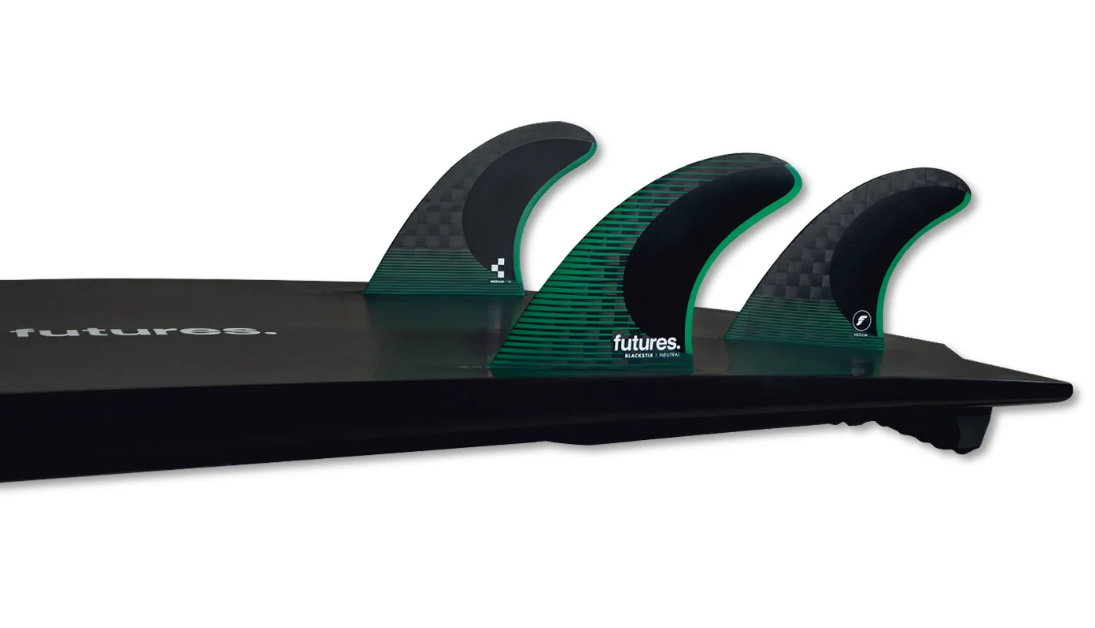 Futures Fins F6 Blackstix Thruster Surfboard Fins black with green in the tail of a black surfboard