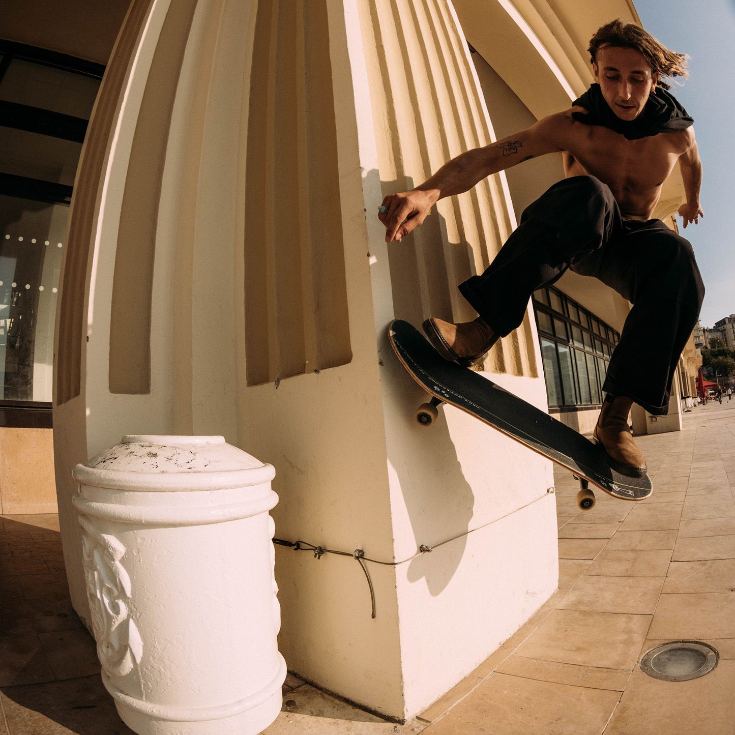 Guy doing an ollie wallride on his skateboard wearing Globe Dover II Leather Boots