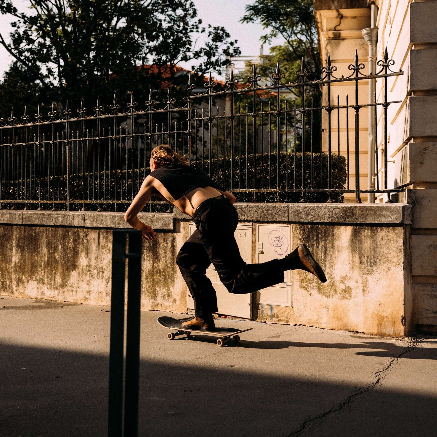 Guy doing a kick push on his skateboard wearing Globe Dover II Leather Boots