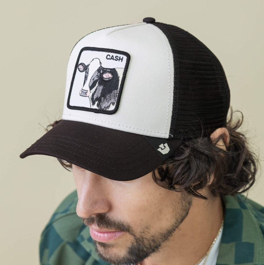 Goorin Bros Cash Cow Trucker Cap in white and black colourway from front/side view, called dust and void colours