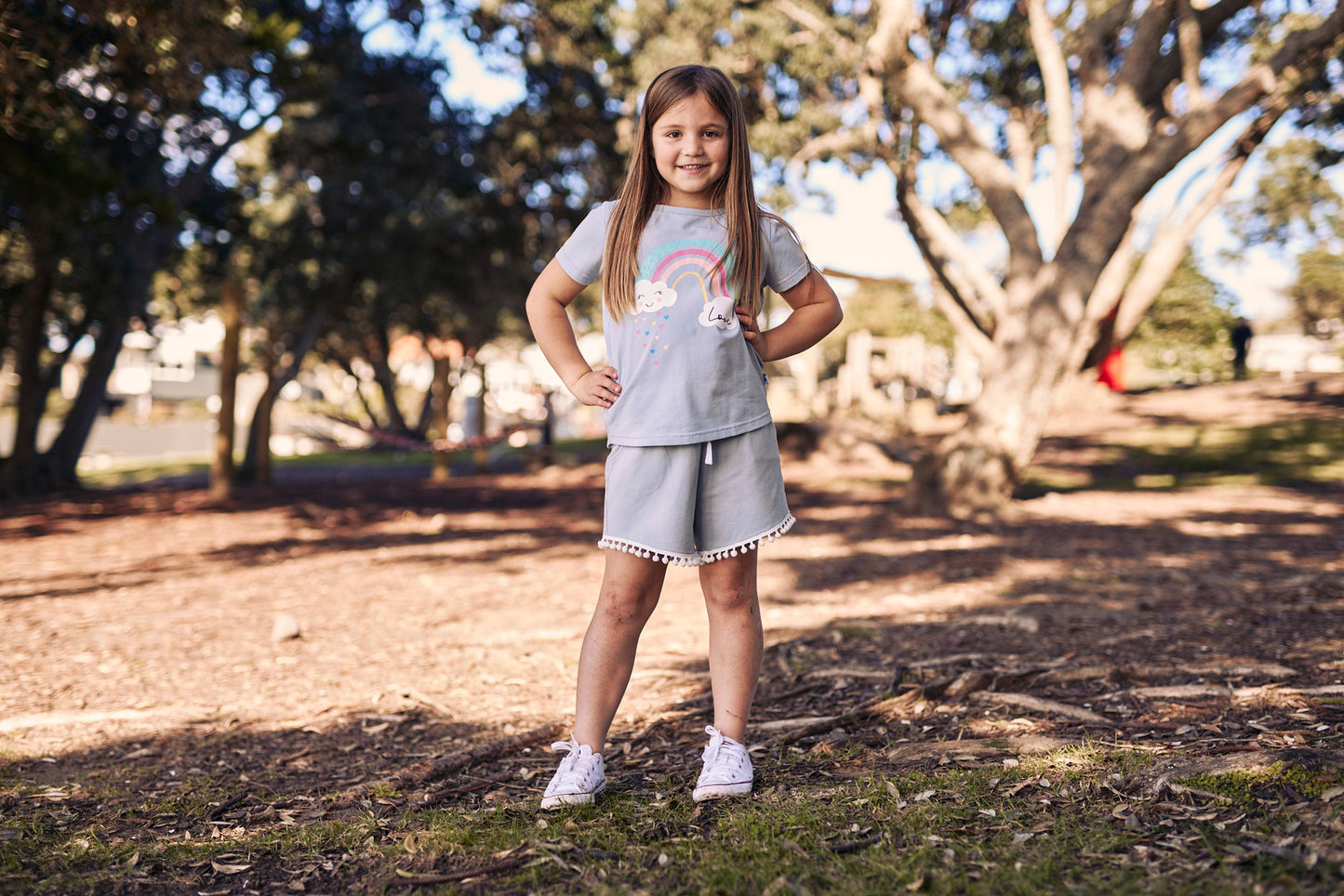 Kissed By Radicool Rainbow Love Tee on model amongst trees