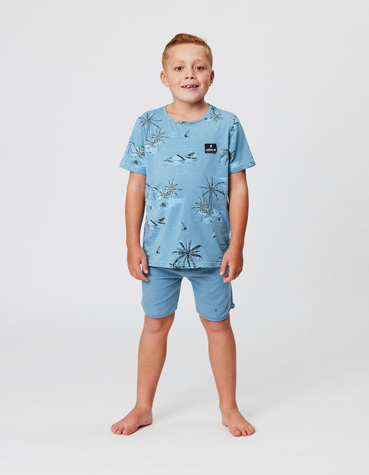Model wearing the Radicool Kids Bermuda Palms Tee in blue
