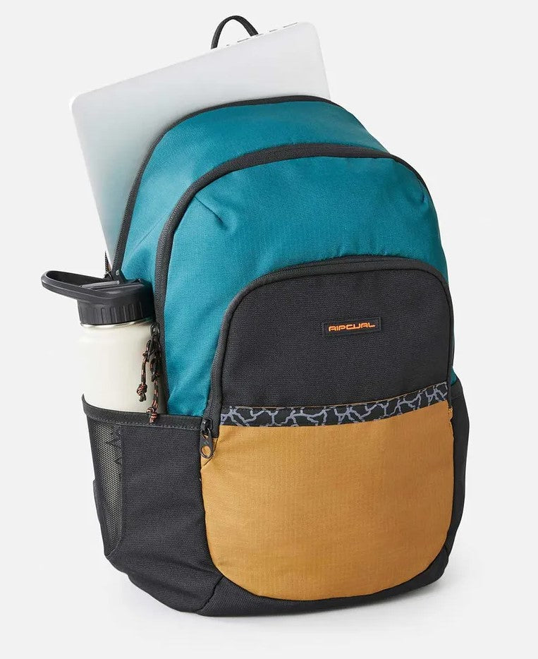 Rip Curl Ozone 33L Journeys Backpack with bottle and laptop showing in pockets in blue green
