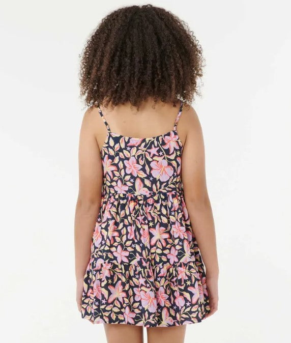 Rip Curl Sunset Skies Girls Dress in navy with floral print on dakr haired model from rear