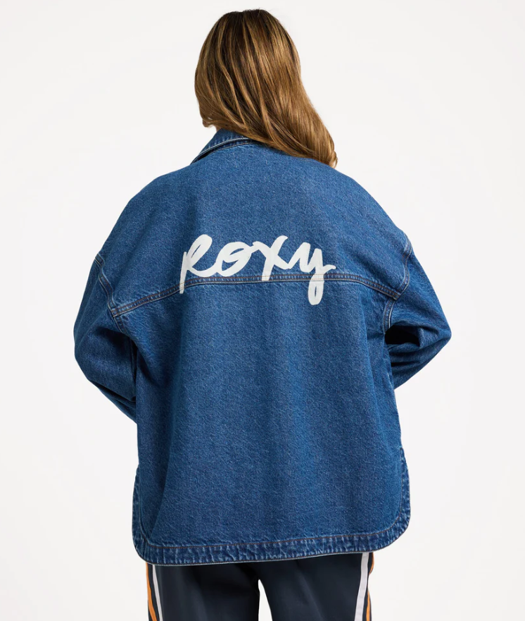 Roxy Backslider Women's Denim Jacket in blue on model from rear showing large Roxy print