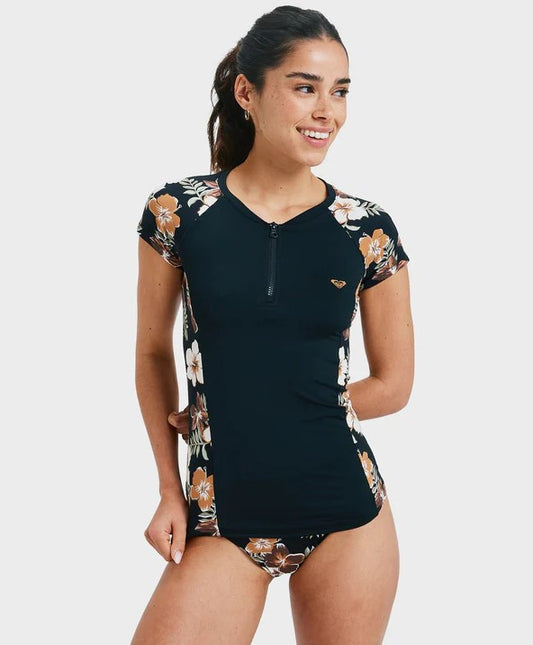 Roxy Cap Sleeve Half Zip Lycra  in black with almond tropical feels detailing on side on model from front