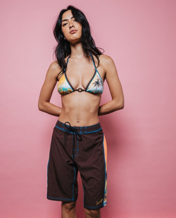 Rusty La Cabana Low Rise Long Womens Boardshorts in java colourway on model in multi coloured bikini top
