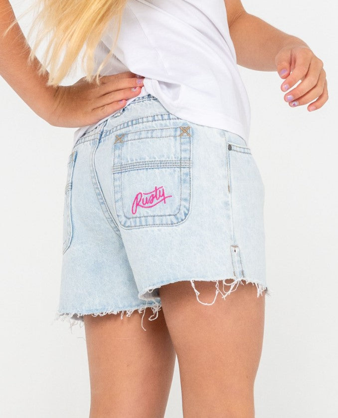 Rusty Penny Kick Flare Girls Denim Shorts in sky blue heather on model in white t-shirt from rear showing pocket embroidery