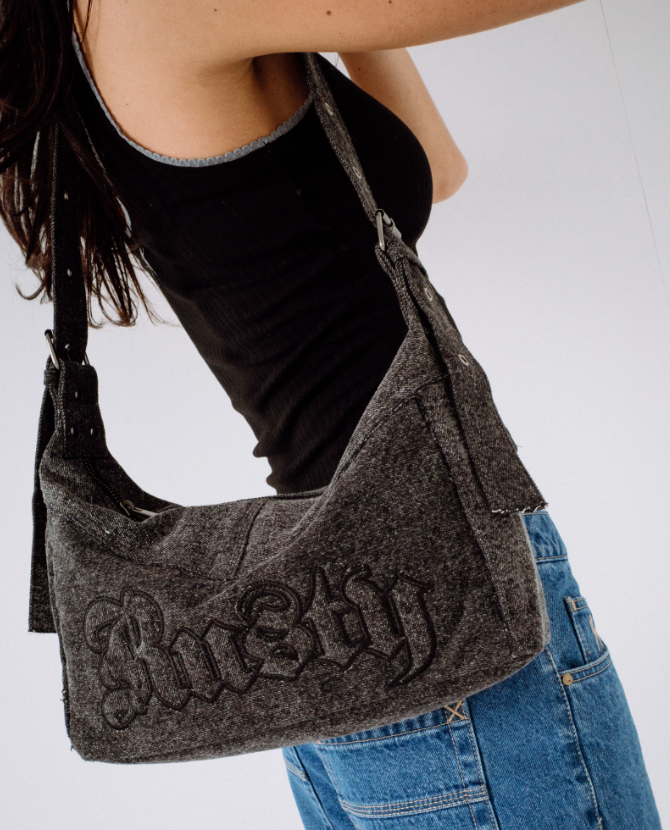 Rusty Roxanne Denim Shoulder Bag in washed black on model's shoulder