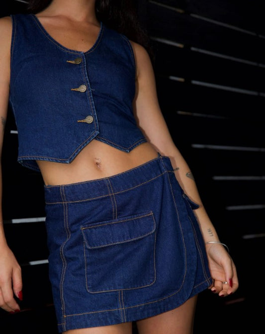 Rusty Ryley Cropped Button Down Denim Vest in deep blue on model by black fence