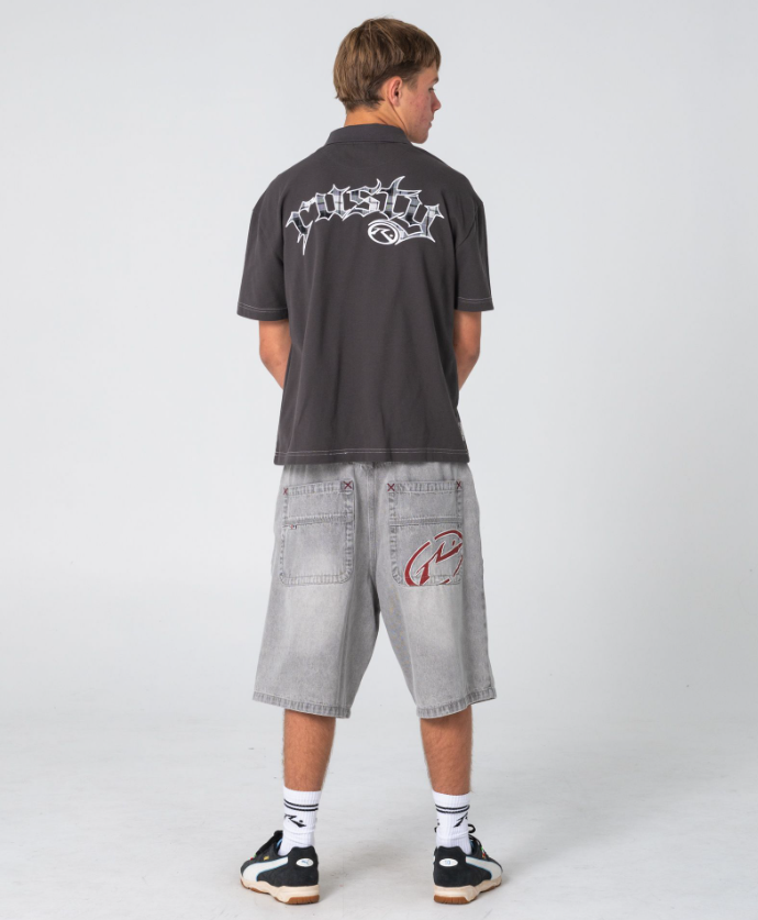 Rusty Turbo 2.0 Baggy 24" Denim Shorts in storm grey colourway on model in Rusty polo from the back