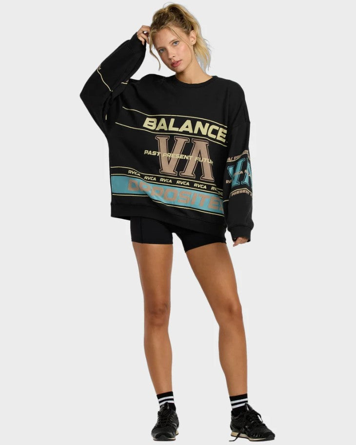 RVCA Puck It Pullover Crew Womens Sweatshirt in black on blonde model in cycling shorts from front