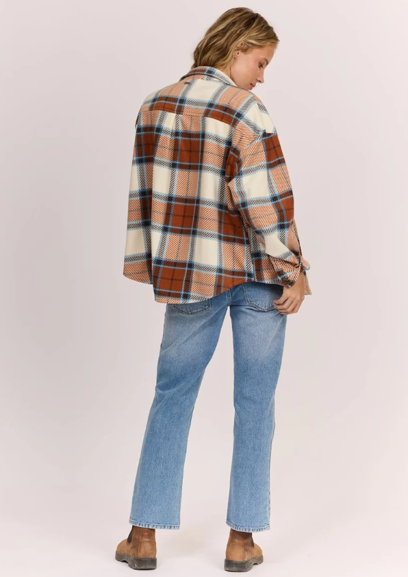 Sisstrevolution Washed Ashore Women's Fleece in terracotta colourway on model in blue jeans from rear