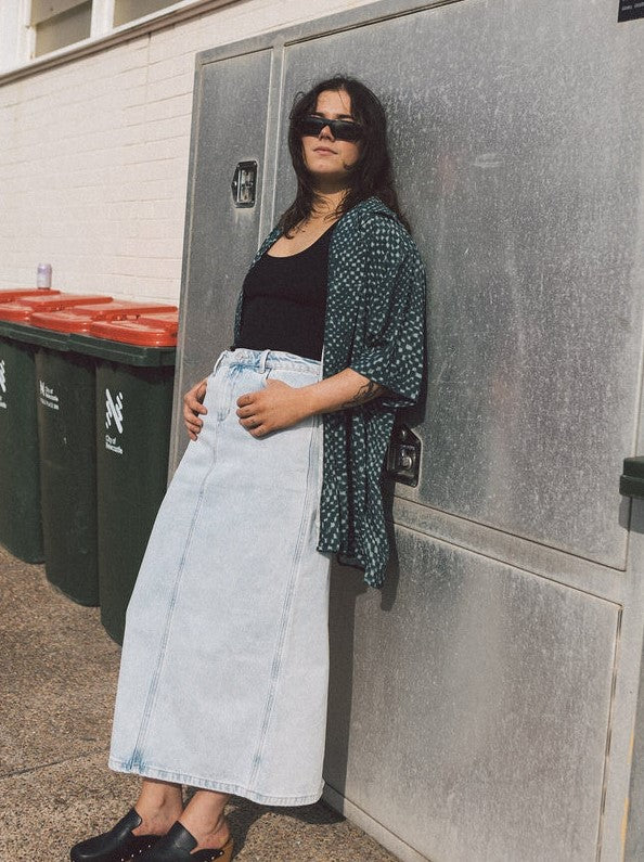 Thrills Frankie Denim Skirt being worn by a model in an outdoor work area