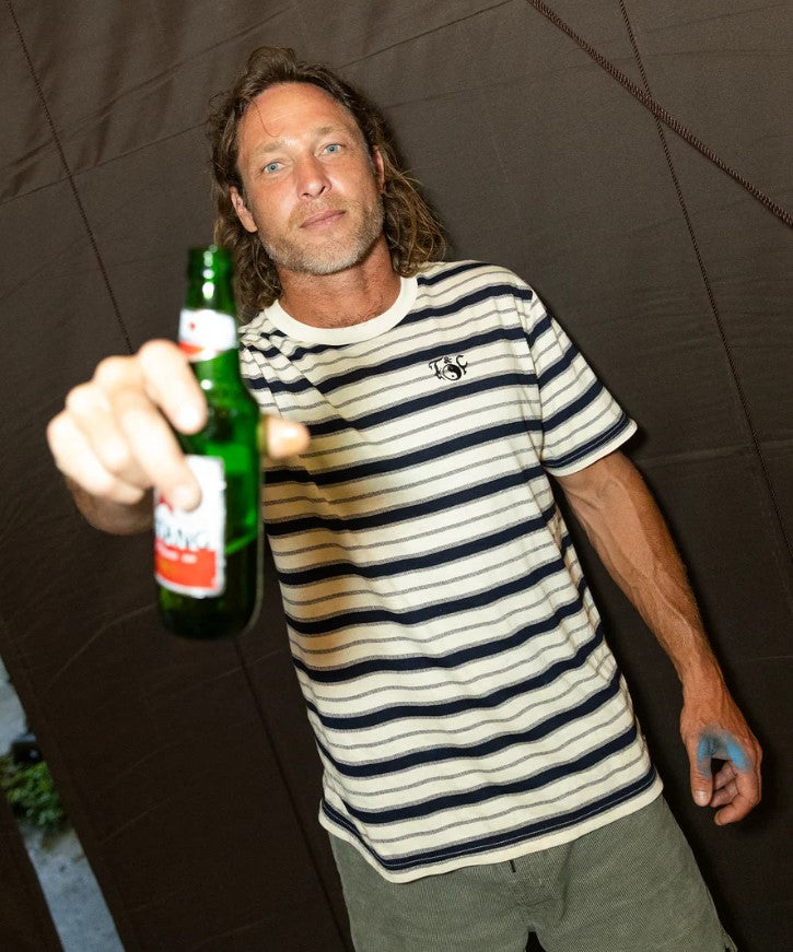 Town and Country Nomad Stripe Mens T-Shirt in bone with black stripes on model holding a beer