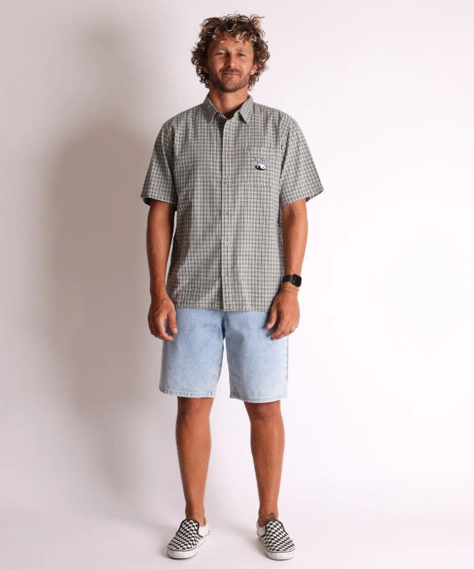 Town and Country Transit Short Sleeve Shirt in grey check with embroidered pocket patch on model wearing denim shorts