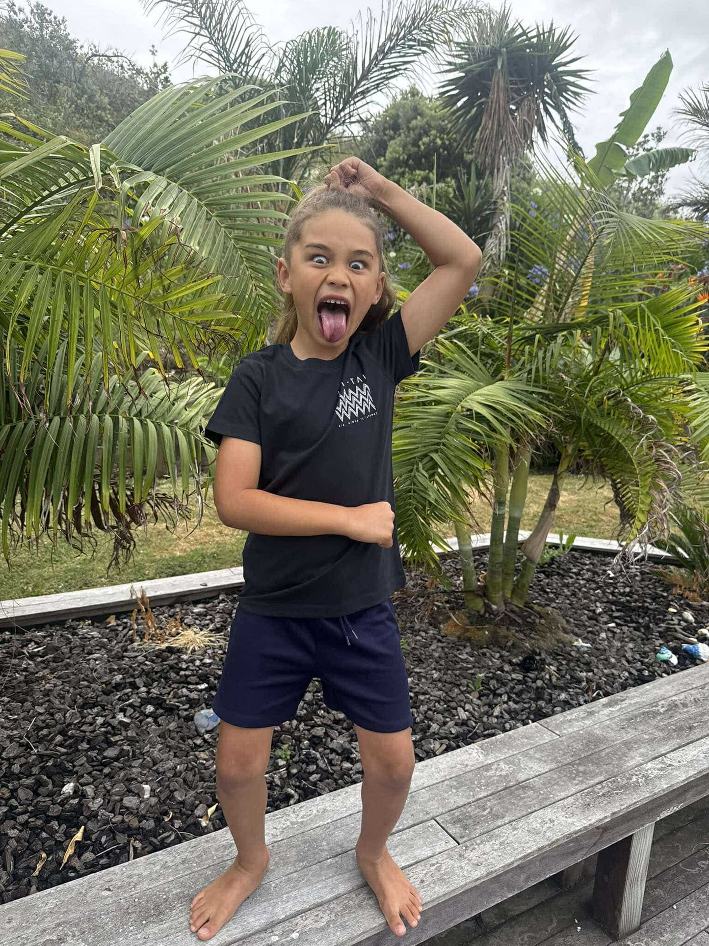 Wai-Tai Kids Mangopare Tee in navy with kid doing pukana