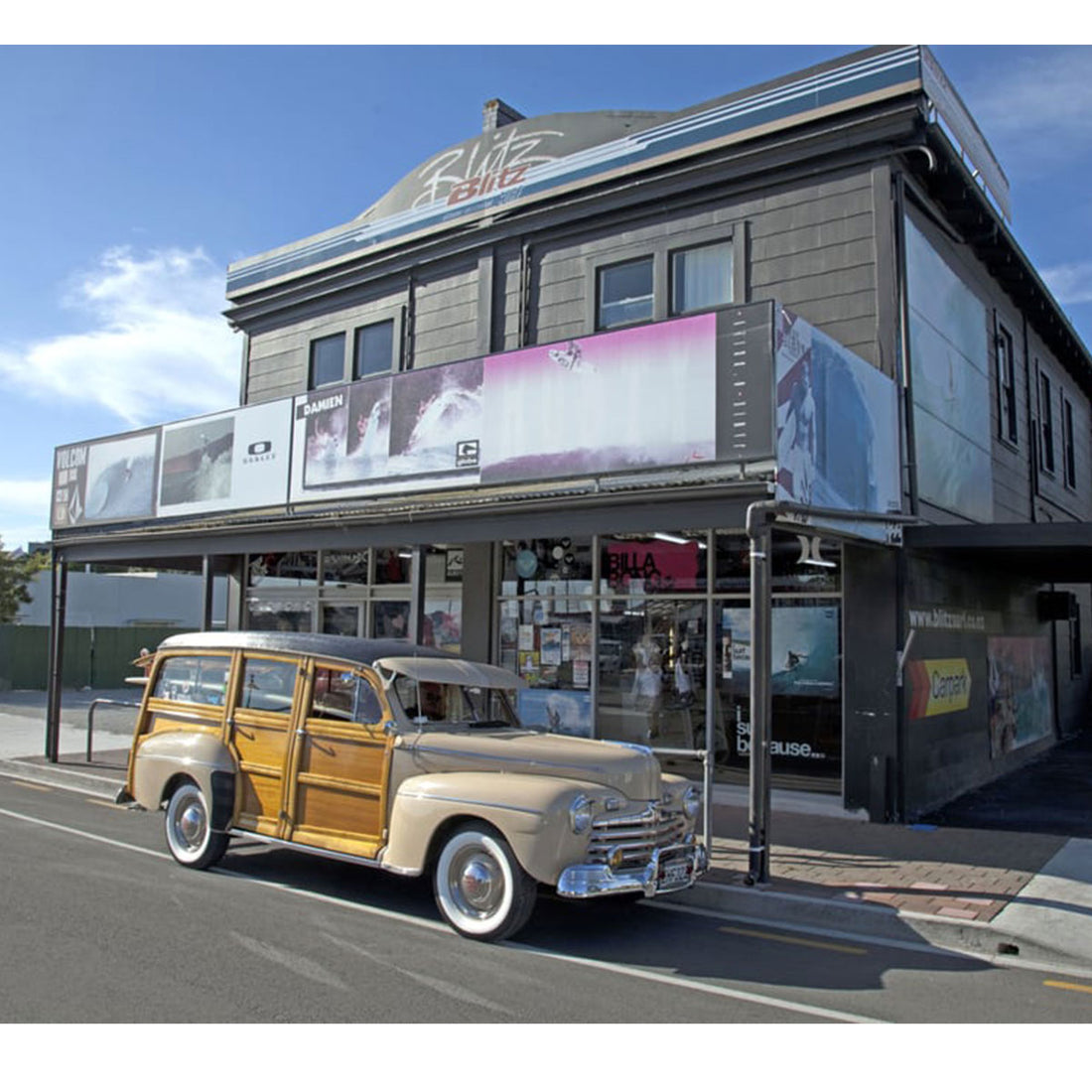 Blitz Surf Shop with woody surf wagon car in front of it