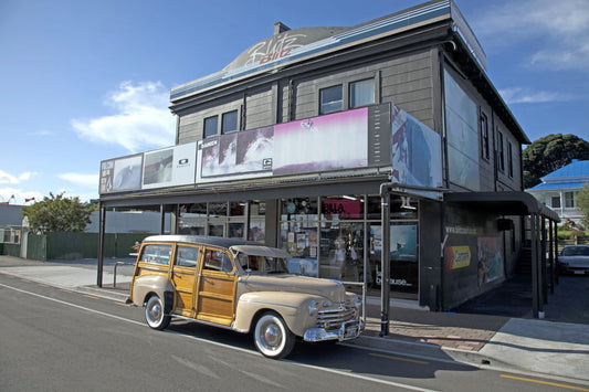 Blitz Surf Shop Gisborne with a woddy surf wagon outside on Wainui Road