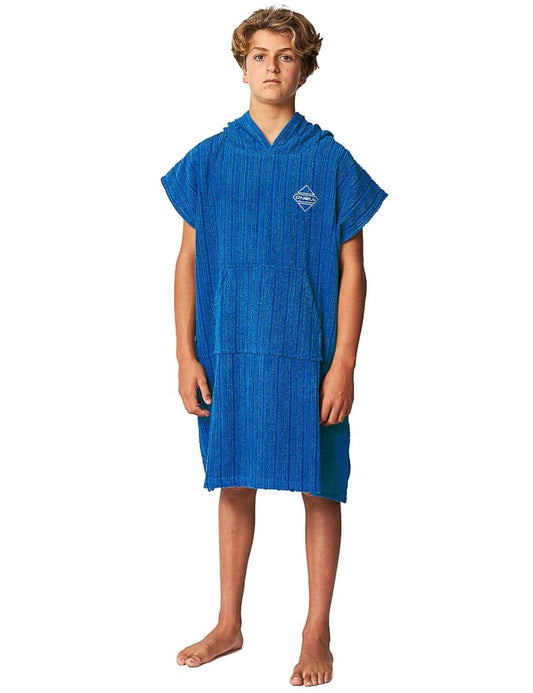 Young man wearing an O'Neill TB3X hooded towel poncho in deep blue colour