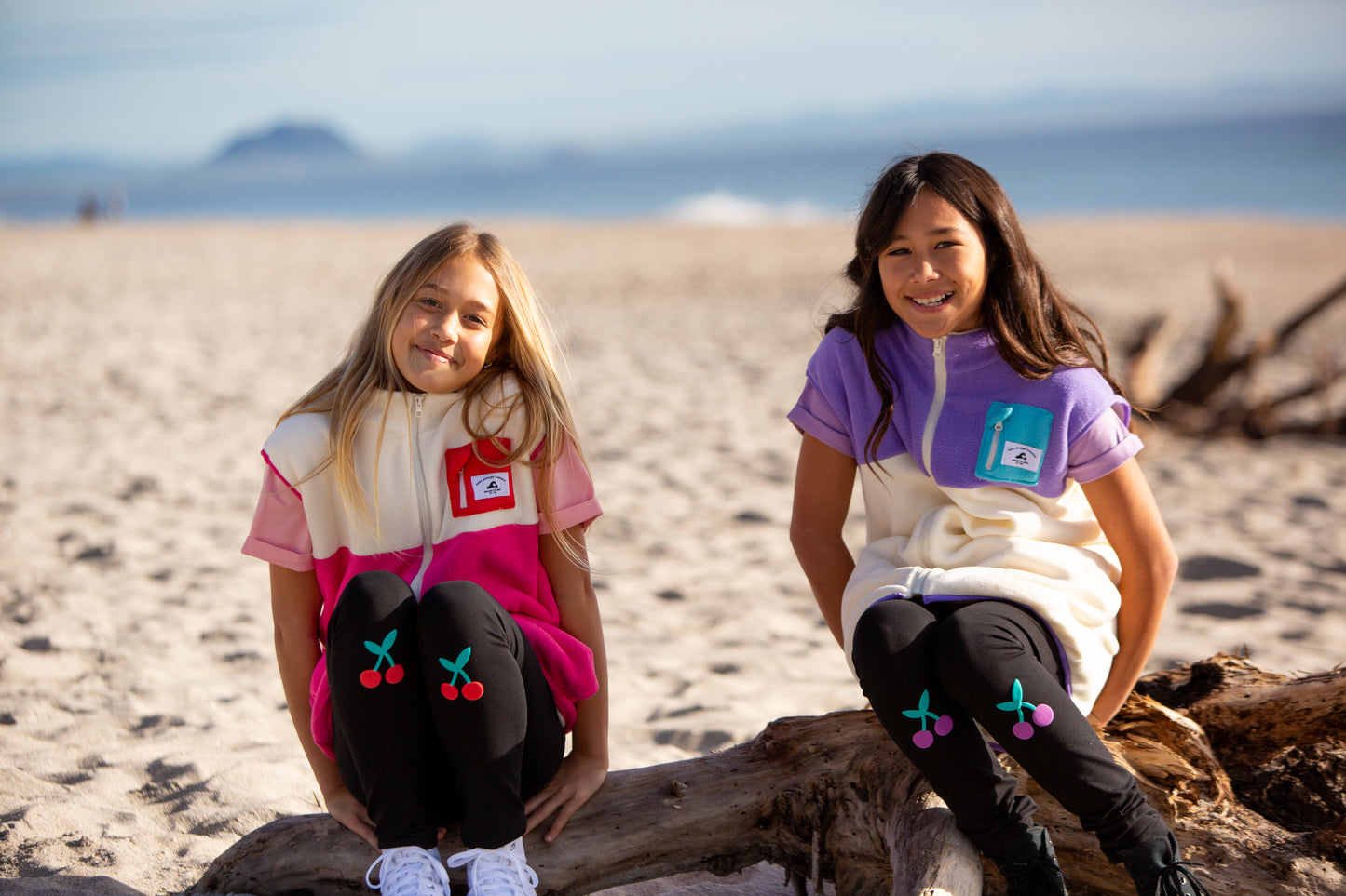 Hello Stranger Girls Leggings
 showing both red and purple cherry versions on 2 young models at the beach